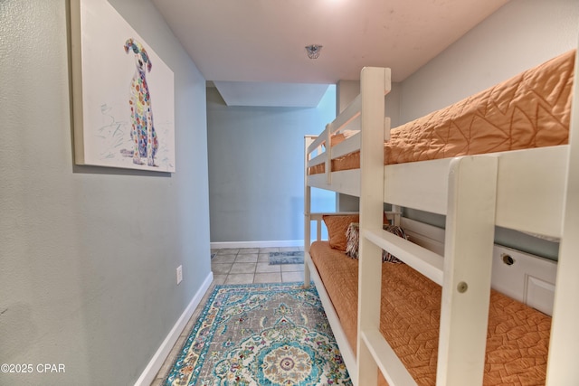 corridor featuring tile patterned floors and baseboards