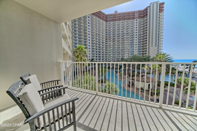 balcony featuring a city view and a water view