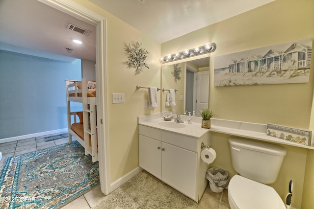 bathroom featuring vanity, baseboards, visible vents, tile patterned flooring, and toilet