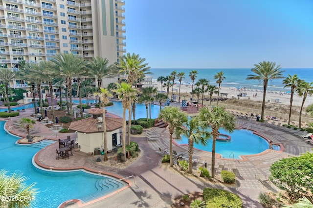 community pool featuring a patio and a water view