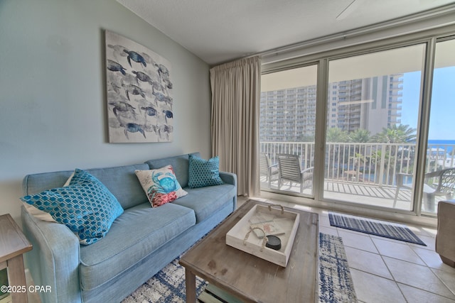 tiled living room featuring visible vents and a textured ceiling