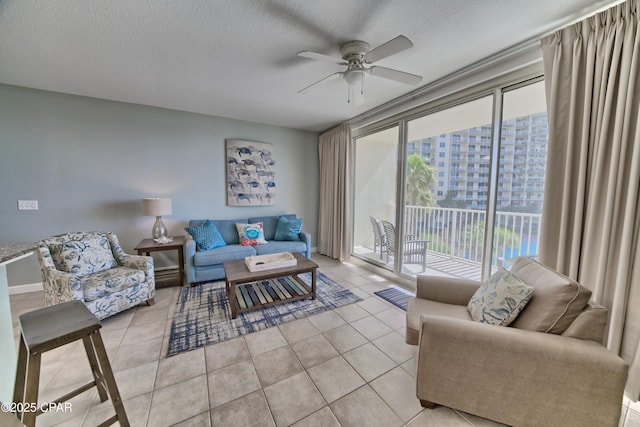 living area featuring light tile patterned flooring, visible vents, a textured ceiling, and ceiling fan