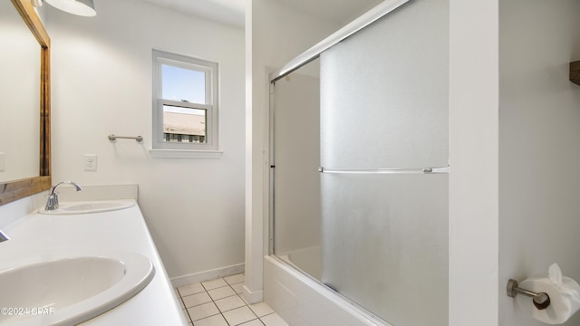 bathroom featuring double vanity, combined bath / shower with glass door, a sink, and tile patterned floors