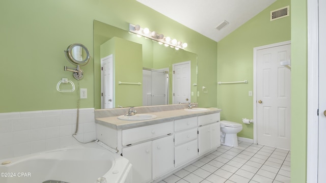 bathroom with visible vents, vaulted ceiling, a sink, and tile patterned floors