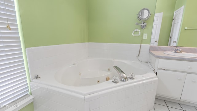 bathroom with tile patterned flooring, a jetted tub, and vanity