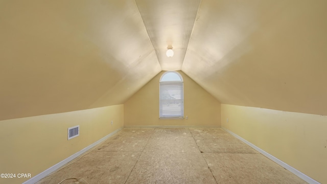 additional living space with visible vents and vaulted ceiling