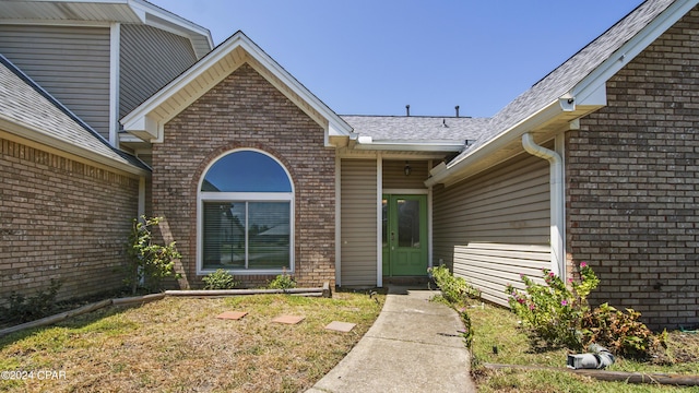 property entrance featuring brick siding