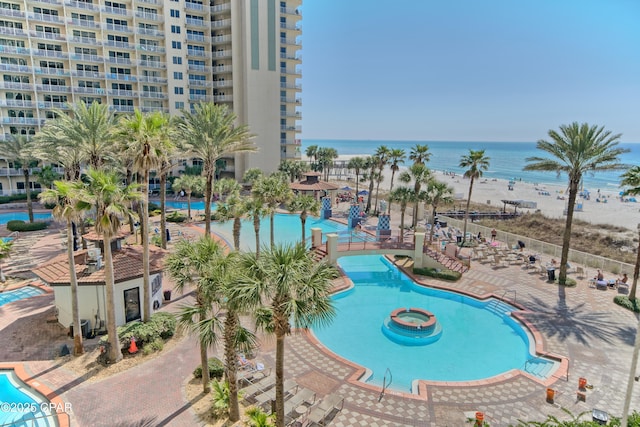 pool featuring a water view and a patio