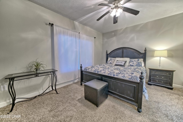 carpeted bedroom with baseboards, a textured ceiling, and ceiling fan