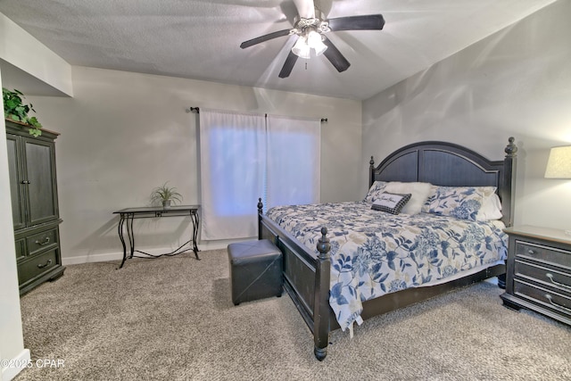 carpeted bedroom featuring a ceiling fan, baseboards, and a textured ceiling