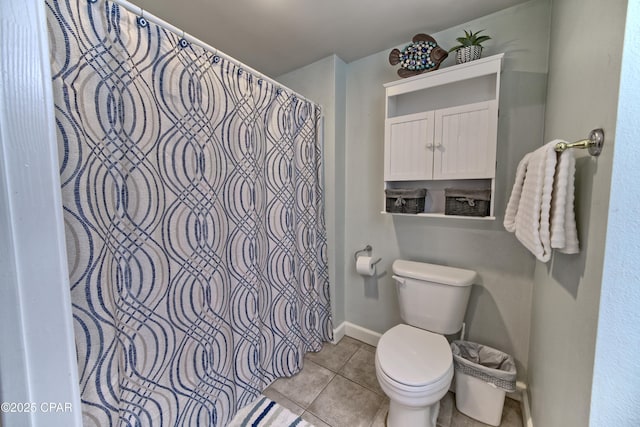 bathroom featuring curtained shower, baseboards, toilet, and tile patterned flooring