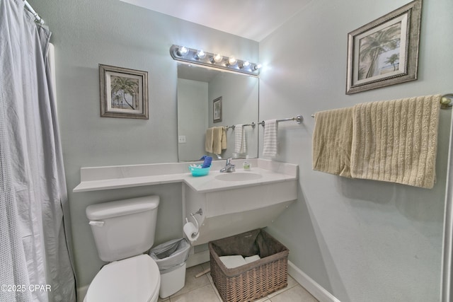 bathroom with toilet, curtained shower, tile patterned flooring, baseboards, and vanity