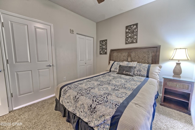 carpeted bedroom with a ceiling fan and a closet