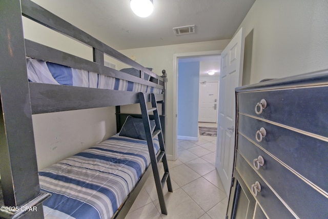 bedroom featuring light tile patterned floors, baseboards, and visible vents