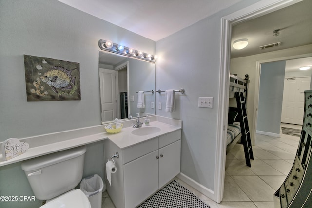 bathroom with visible vents, baseboards, toilet, tile patterned floors, and vanity