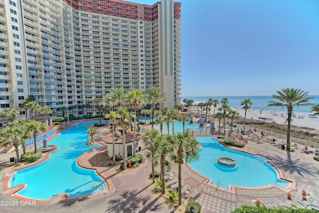 view of swimming pool featuring a water view