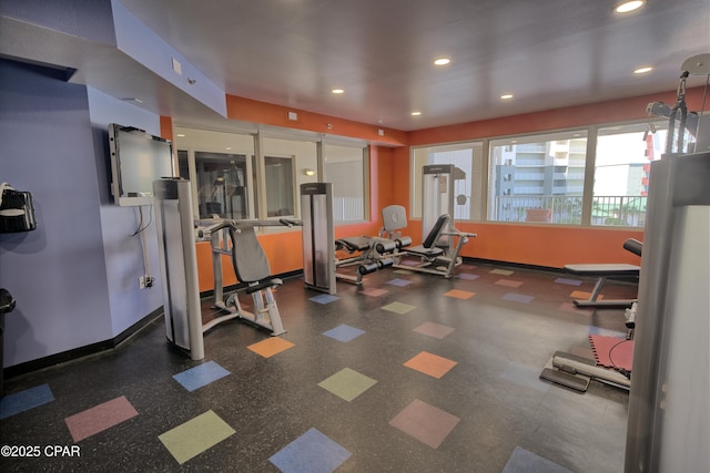 workout area featuring recessed lighting and baseboards