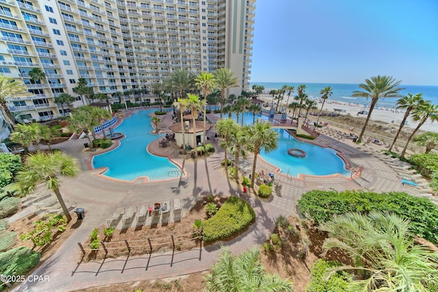 view of swimming pool featuring a water view