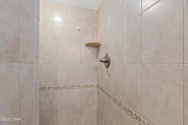 bathroom with tiled shower