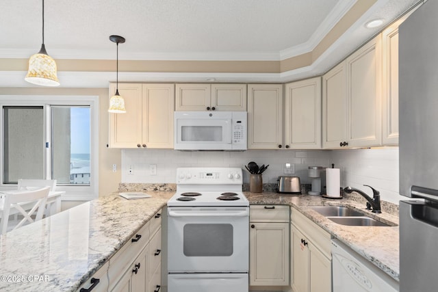 kitchen with white appliances, crown molding, decorative backsplash, and a sink