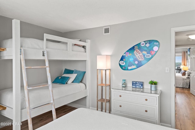 bedroom featuring visible vents and wood finished floors