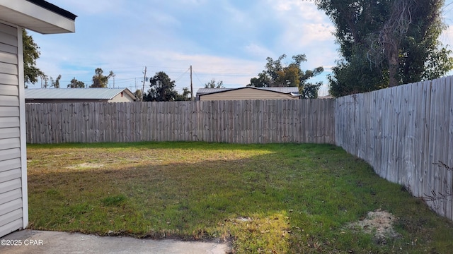 view of yard with a fenced backyard