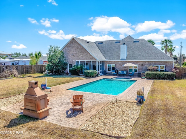 view of pool featuring a fenced in pool, fence, a yard, and a patio area
