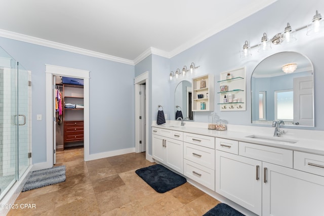 bathroom featuring double vanity, a shower stall, crown molding, and a sink