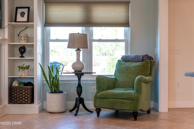 sitting room featuring tile patterned flooring and plenty of natural light