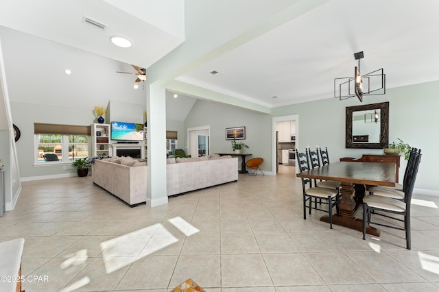living room with light tile patterned floors, a ceiling fan, and vaulted ceiling