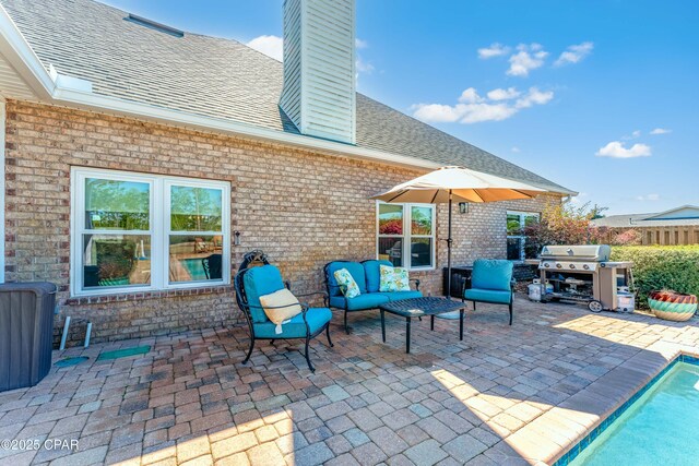 view of patio with a grill, fence, an outdoor hangout area, and a fenced in pool