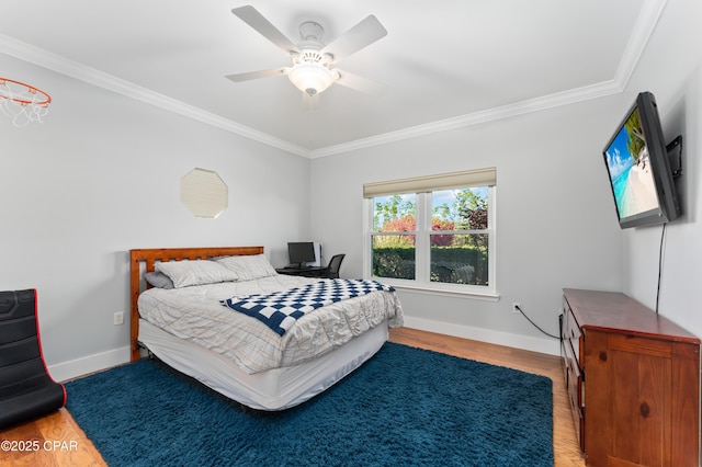 bedroom with ornamental molding, ceiling fan, wood finished floors, and baseboards