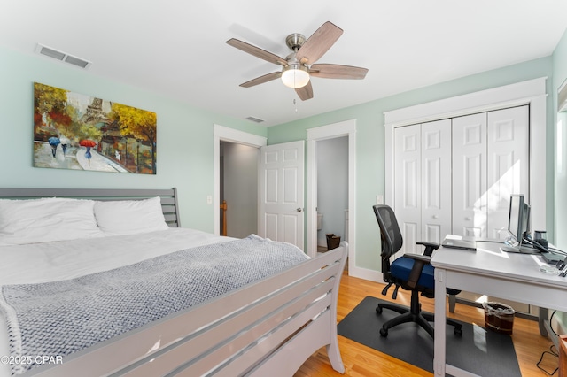 bedroom with light wood-style flooring, a closet, baseboards, visible vents, and a ceiling fan