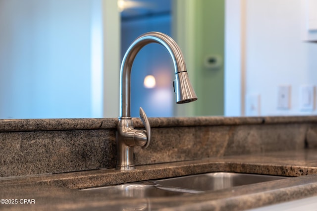 interior details with dark countertops and a sink