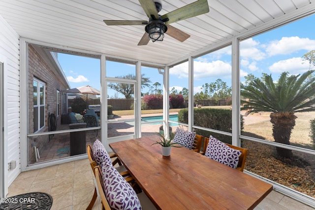 sunroom / solarium with outdoor dining space and a ceiling fan