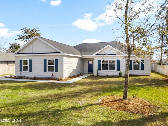 view of front of home featuring board and batten siding, a shingled roof, fence, and a front lawn