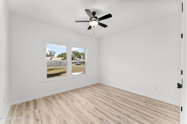empty room with light wood-style flooring, ceiling fan, and baseboards