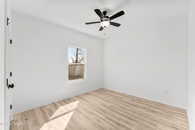 empty room with light wood-style flooring, ceiling fan, and baseboards