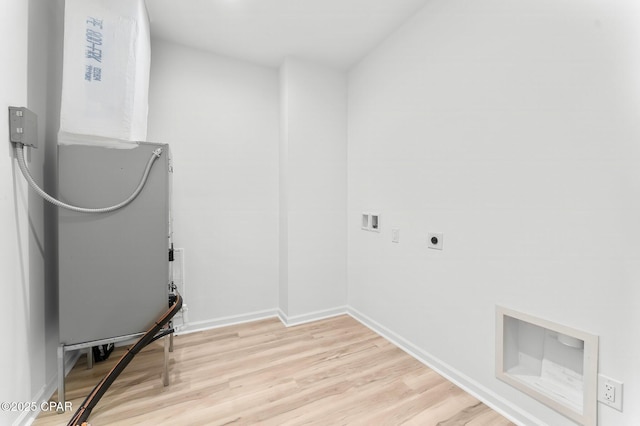 laundry room featuring laundry area, hookup for a washing machine, electric dryer hookup, light wood-style flooring, and baseboards