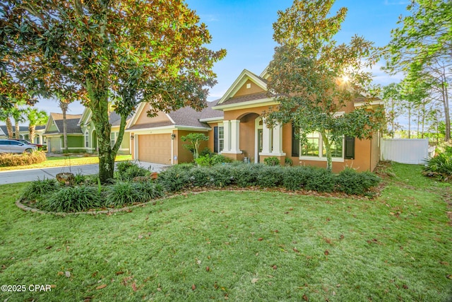 view of front of house featuring driveway, an attached garage, a front yard, and stucco siding