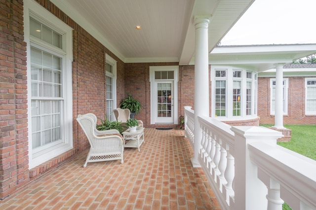 balcony with covered porch and a sunroom