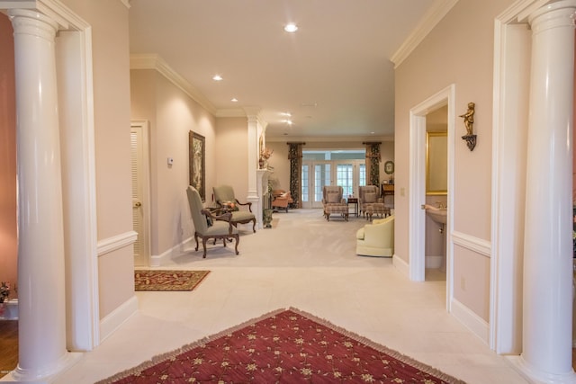 hallway featuring baseboards, ornamental molding, recessed lighting, tile patterned floors, and ornate columns