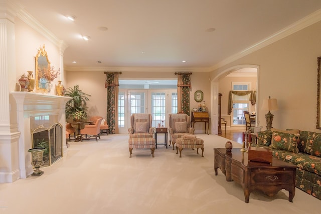 living room featuring plenty of natural light, arched walkways, carpet flooring, and crown molding