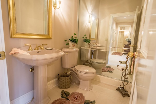 bathroom featuring tile patterned floors, baseboards, and toilet