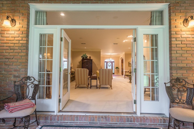 view of exterior entry with brick siding