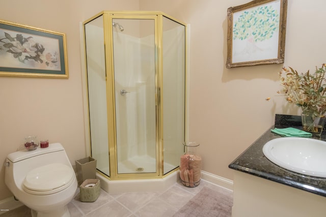 bathroom featuring vanity, baseboards, a shower stall, tile patterned floors, and toilet