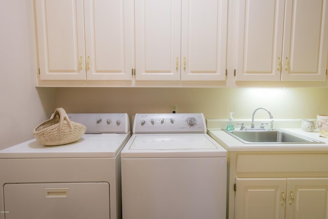 laundry room featuring cabinet space, washer and dryer, and a sink