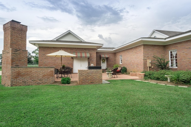 back of house with a patio area and brick siding