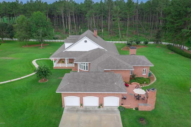 birds eye view of property with a forest view