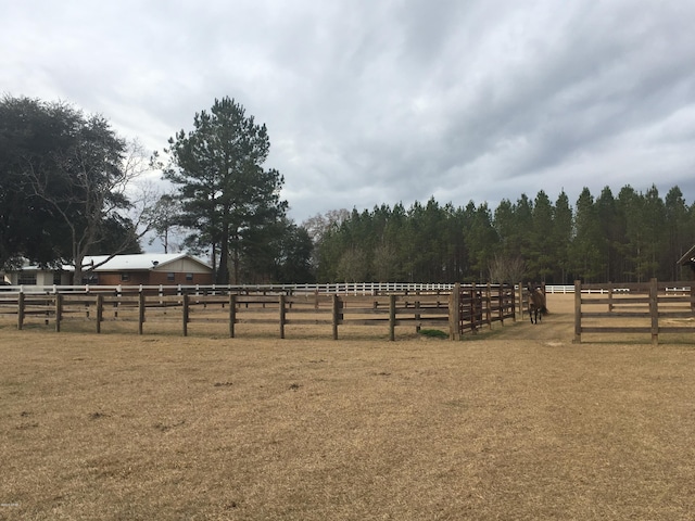 view of yard featuring an enclosed area and a rural view